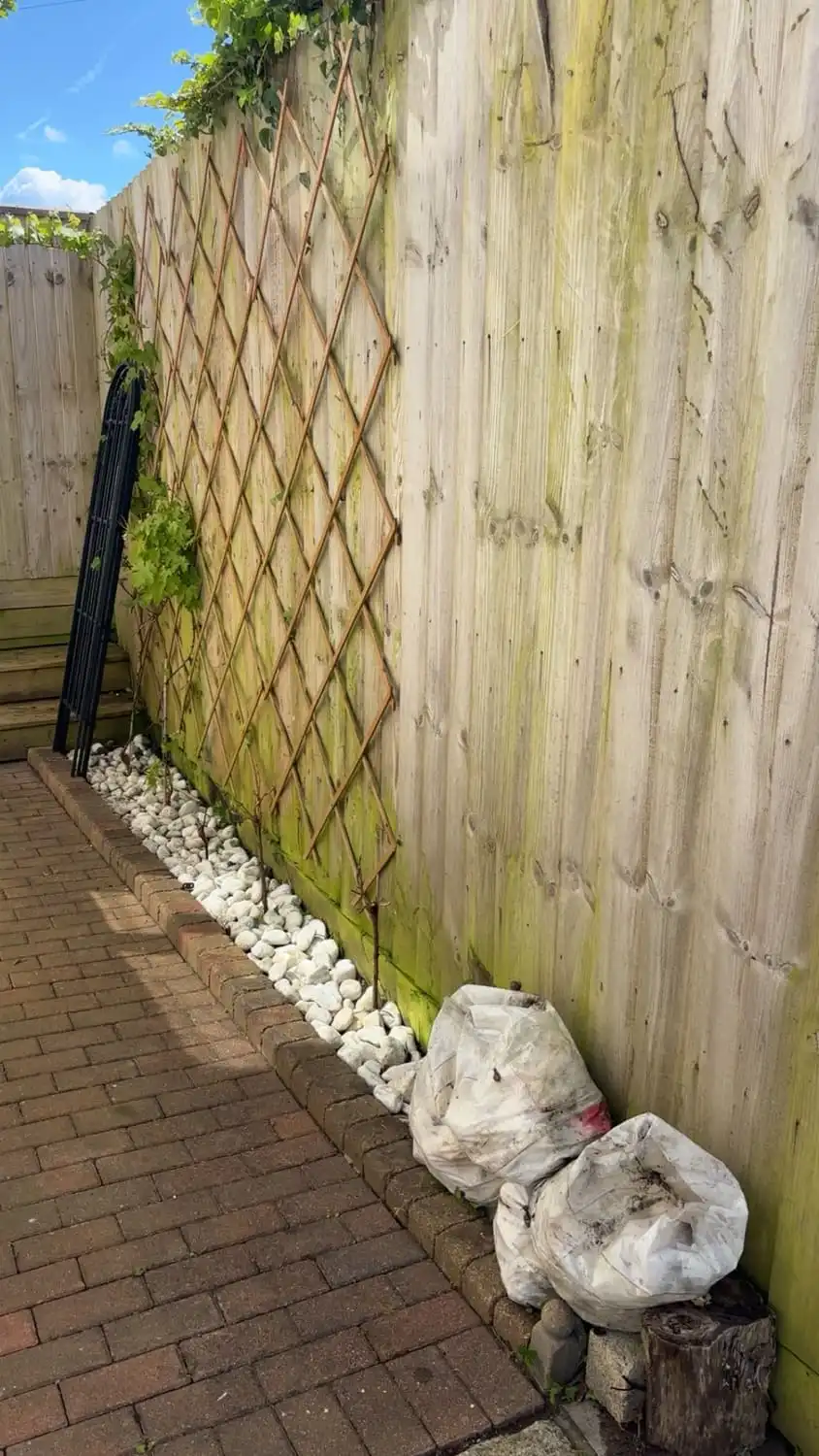 The same passage with the fence and trellis clear and the white stone border visible again