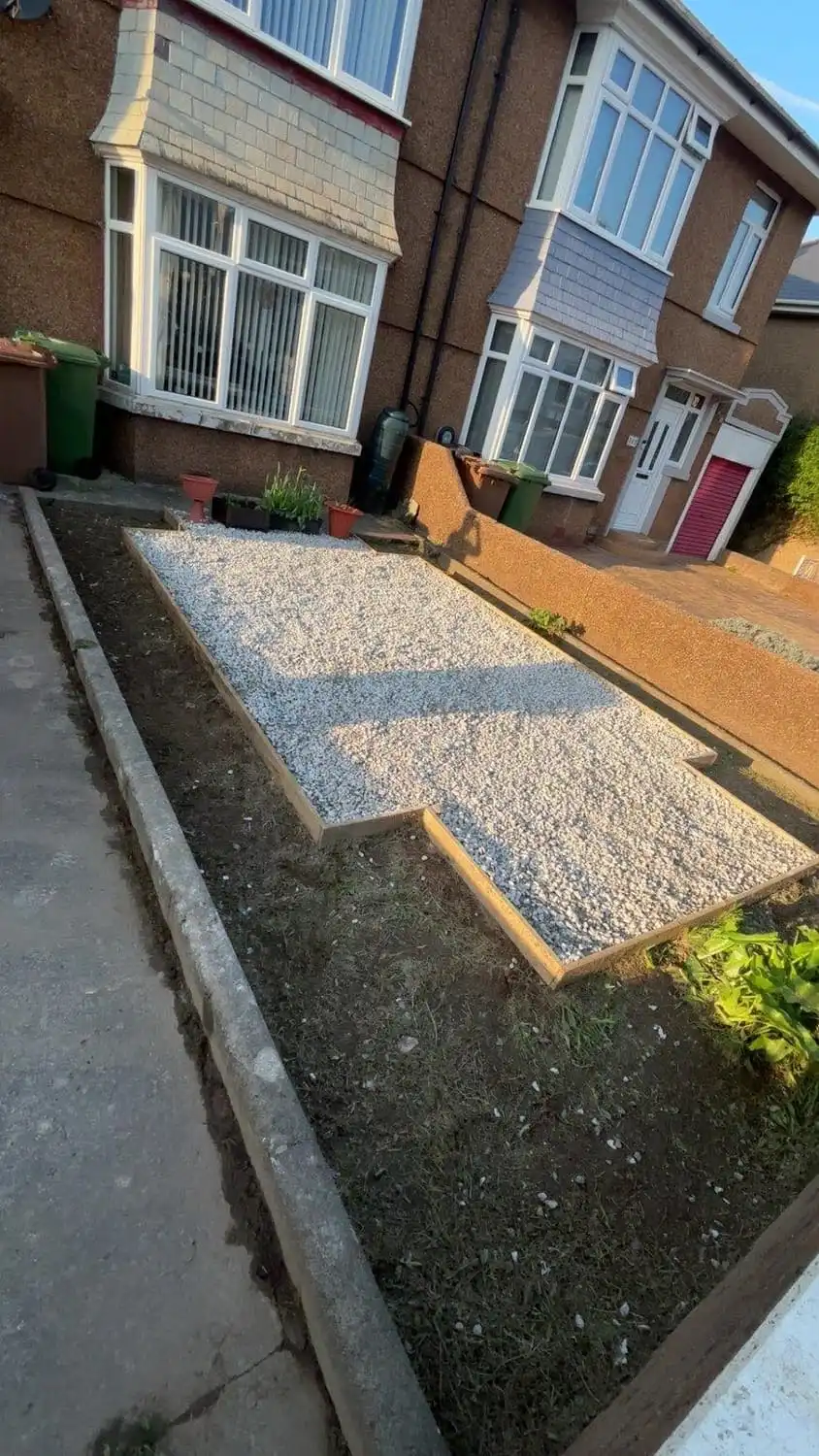 The same area cleared, edged with timber and finished with a clean bed of light gravel