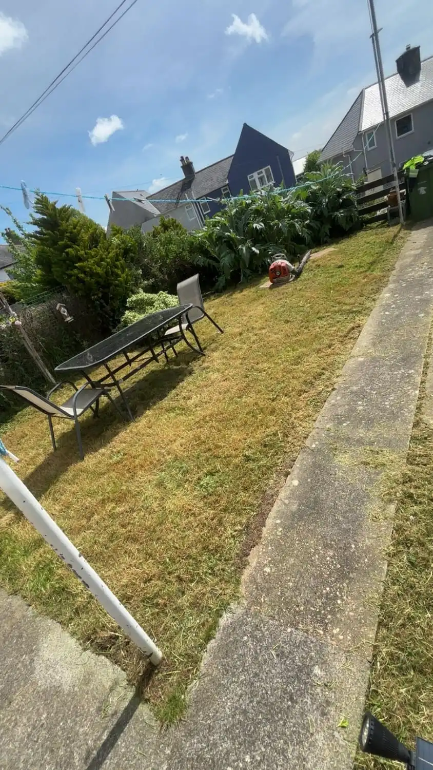 The same path clear with the banks either side cut short and garden furniture set out
