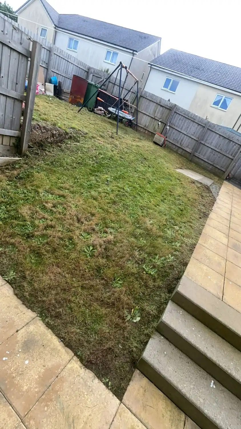 The same sloping garden cut short with the path down the side clear