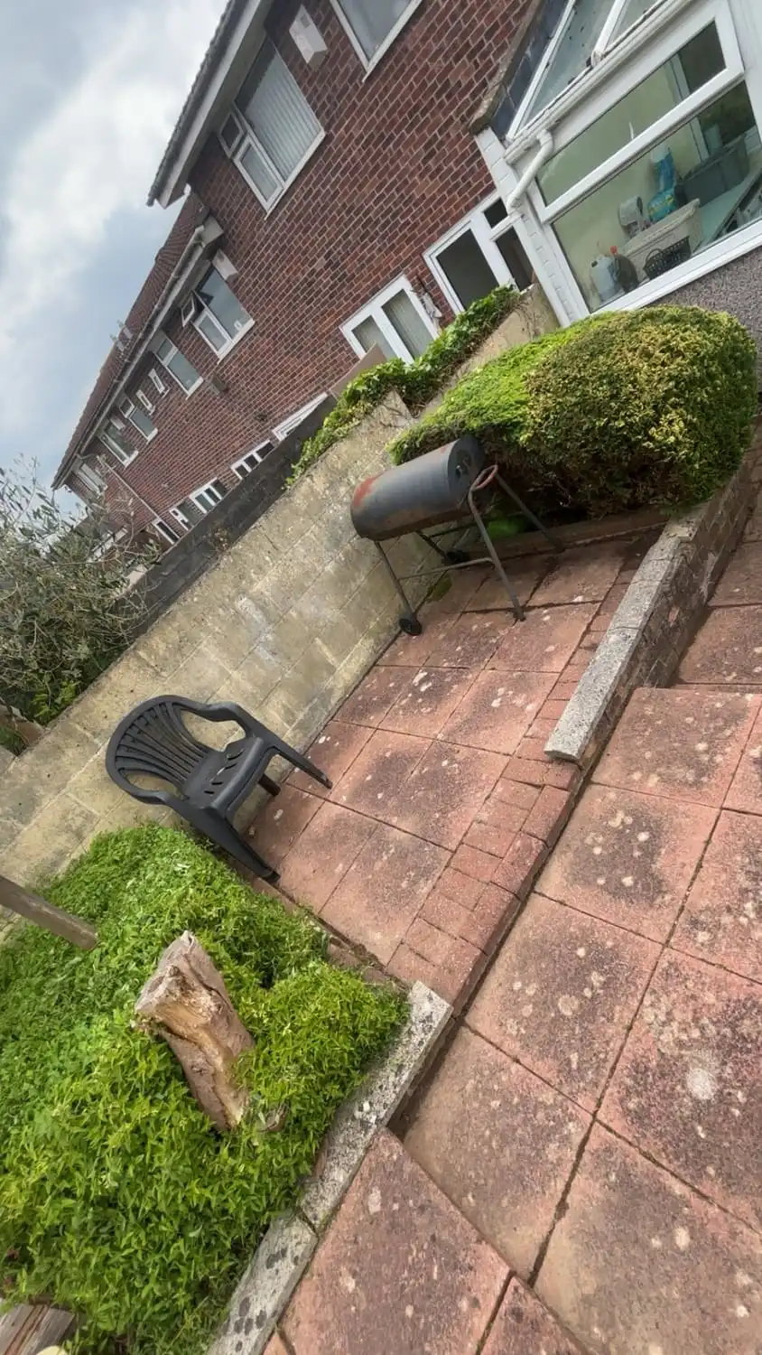 The same patio cleared and washed down with clean joints and the chairs set back out