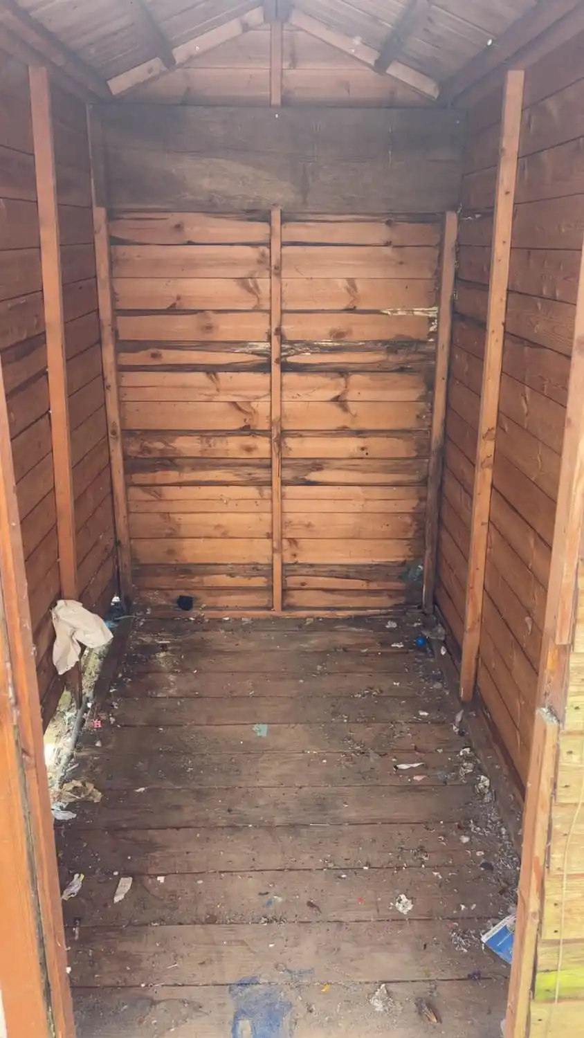 The same shed completely emptied, down to bare timber walls and a swept floor